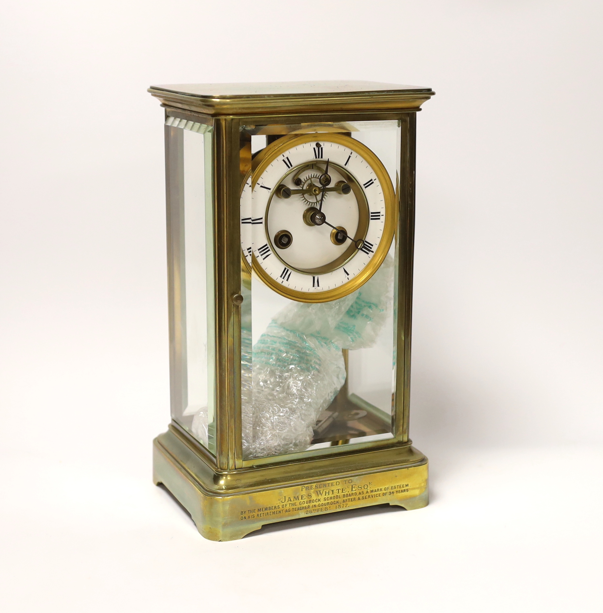 A late 19th century French brass four-glass mantel clock, striking on a bell, engraved to base, with key and pendulum, 27cm